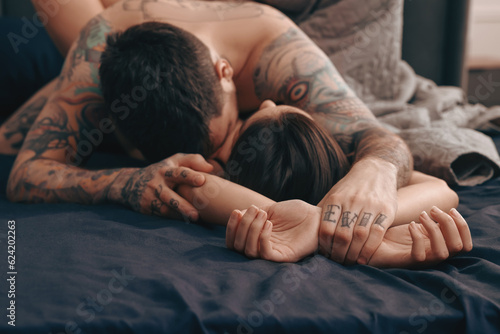 Fotografia Passionate couple having sex on bed, focus on hands