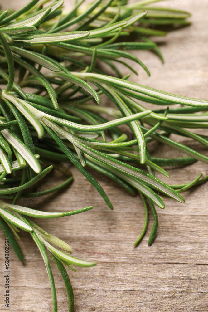 Sprigs of fresh rosemary on wooden table, closeup Sprigs of fresh rosemary on wooden table, closeup