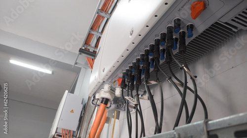 Industrial Instalation of Solar panel inverter with isolators attached to the wall.