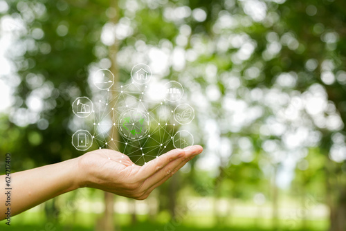 Technology, hand holding with environment Icons over the Network connection on green background.