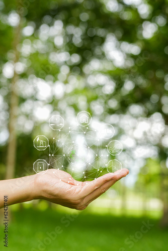 Wallpaper Mural Technology, hand holding with environment Icons over the Network connection on green background. Torontodigital.ca