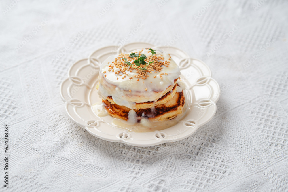 Pancakes topped with whipped cream and bee pollen Pancakes topped with whipped cream and bee pollen