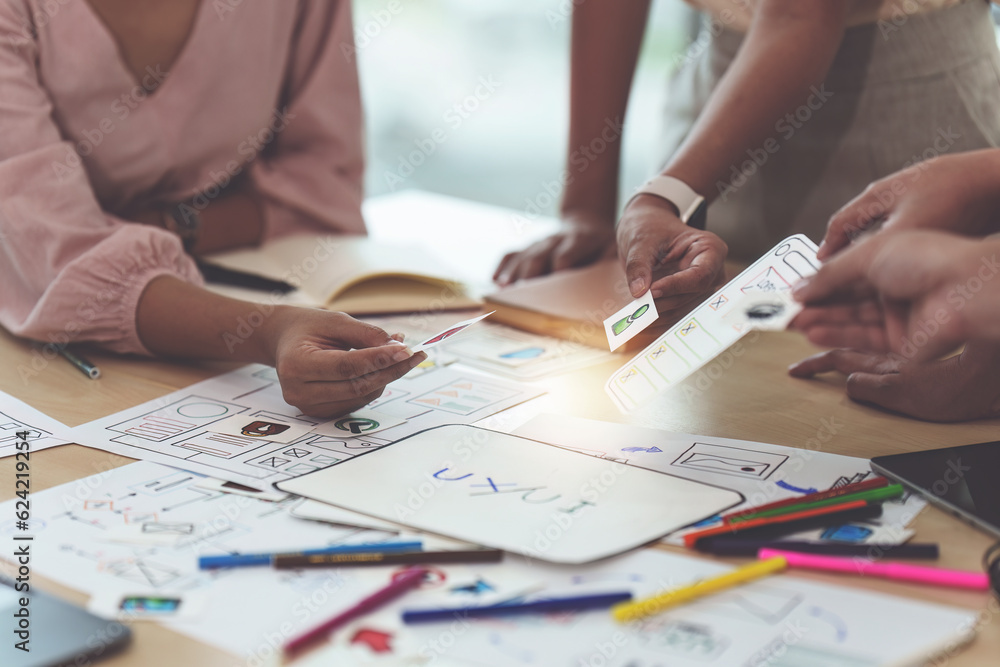 Close up of developer and ui designer brainstorming interface wireframe design.Creative digital development agency Close up of developer and ui designer brainstorming interface wireframe design.Creative digital development agency