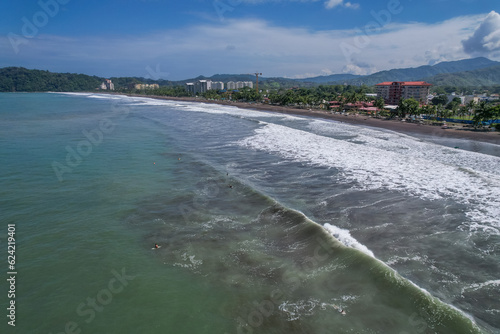 Beautiful aerial view of Jaco Beach, the surf class lessons and the suburb buildings next to the beach photo