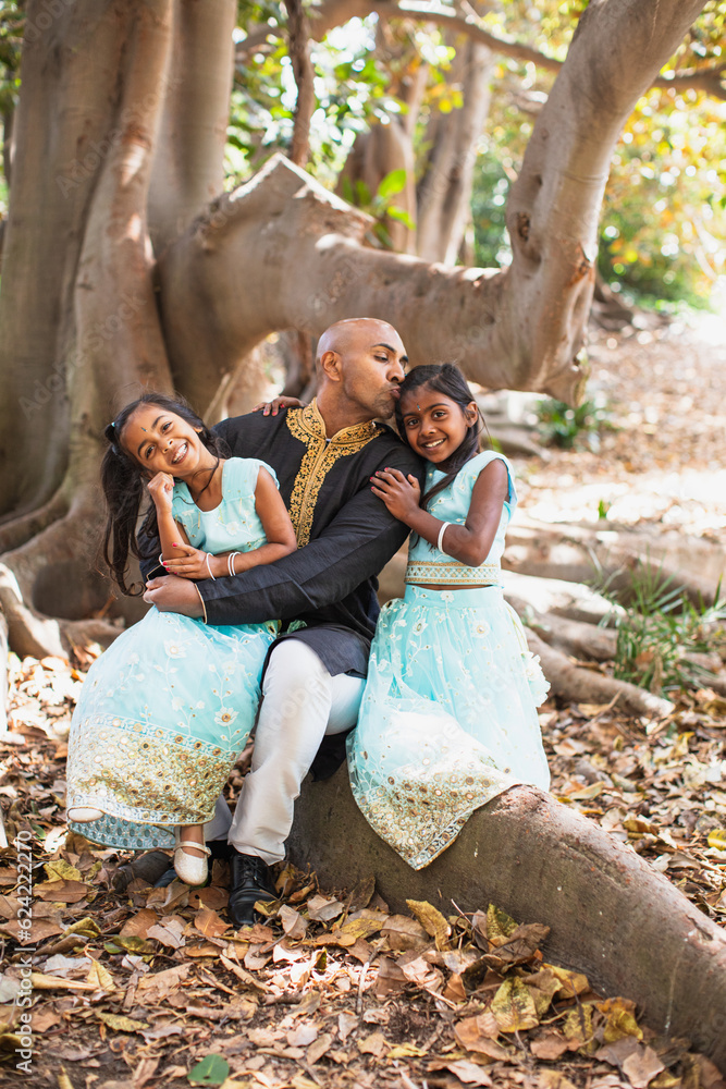 Fototapeta premium father daughter beautiful indian child sisters smiling with a bindi and traditional sari dress and kurta sitting