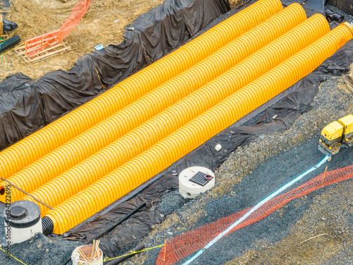 Εκτύπωση καμβά Yellow underground storm water detention mitigation units on a construction site ready to be covered