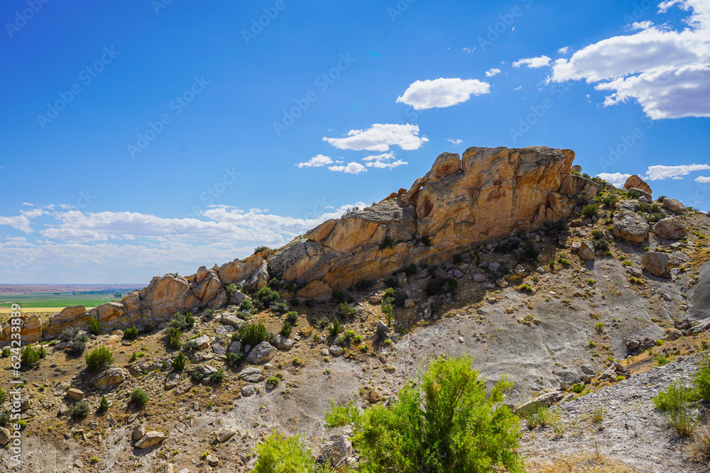 rocky mountain landscape with flat butte and blue sky with clouds rocky mountain landscape with flat butte and blue sky with clouds