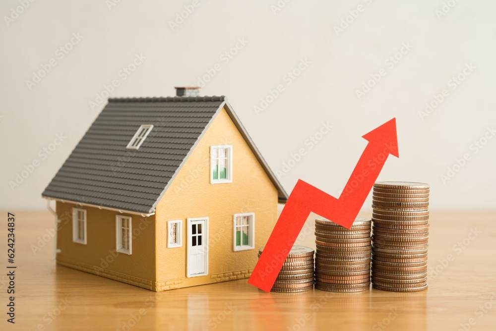Red graph chart rising up on stack coins and house model on wooden table white wall background. Concept of money management for mortgage loan, fed increase interest rate, real estate price increase. - obrazy, fototapety, plakaty 