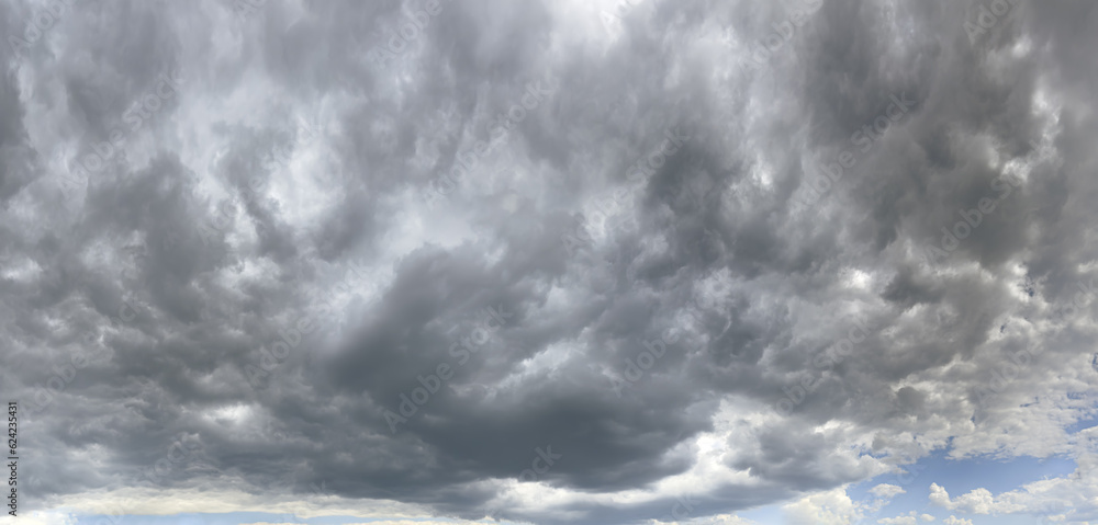 dark overcast sky with stormy clouds before rain. panoramic view. natural sky background. dark overcast sky with stormy clouds before rain. panoramic view. natural sky background.