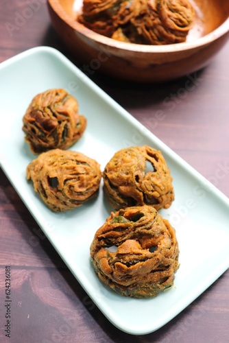 Dry Patra is an Indian dish made with colocasia leaves that are coated with a spicy gram flour batter and deep fried. It's a popular dish in Gujarat. Also known as Patra ni, bardoli's Karara patra.  photo
