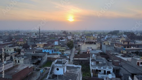Aerial cityscape of small city or town in India at dusk. Drone view of Shahkot near District Jalandhar, Punjab, India. Generic aerial view of a Indian town in North India. Sunrise drone shot of town. photo