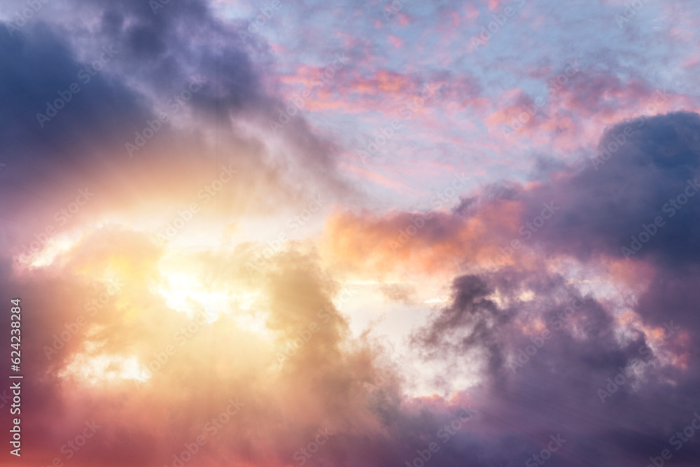 The sun shines through the clouds. Dark, purple pink dramatic sky. The sun shines through the clouds. Dark, purple pink dramatic sky.
