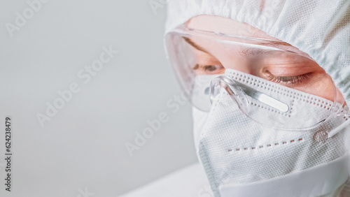 Healthcare scientist. Coronavirus pandemic. Woman doctor nurse laboratory specialist in white protective face mask and goggles glasses isolated on grey background empty space.