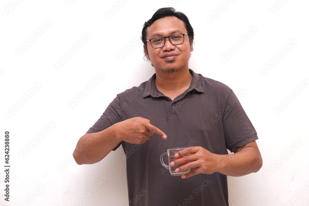 asian man pointing to drinking glass isolated white background asian man pointing to drinking glass isolated white background