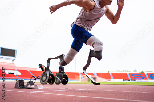 Asian para-athletes disabled with prosthetic blades running at stadium.  © Kawee