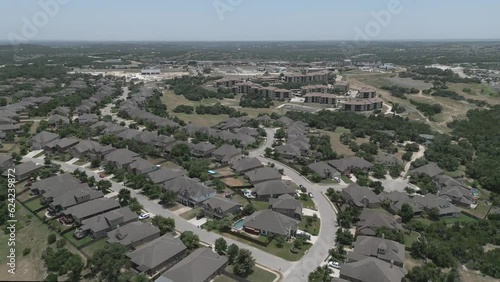 Suburban homes near Austin, Texas are shown in an aerial view of a neighborhood during a summer day.