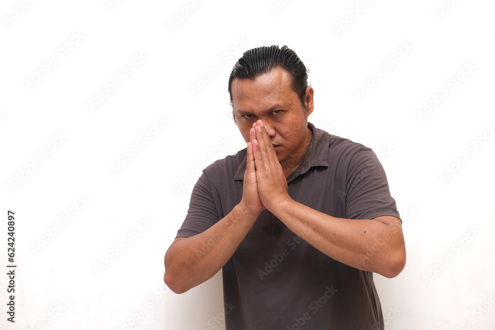 asian man with praying or begging gesture asian man with praying or begging gesture