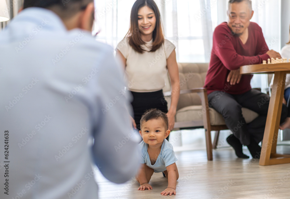 Portrait of enjoy happy love family asian mother playing and teaching help adorable little asian baby learning to crawling.Mom help first step with cute son beginnings development at home.Love, family