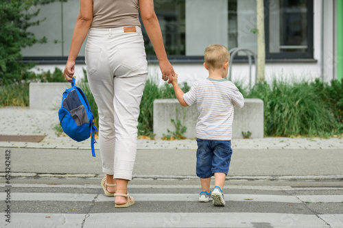 Canvas Print Crop images of mother with son crossing street