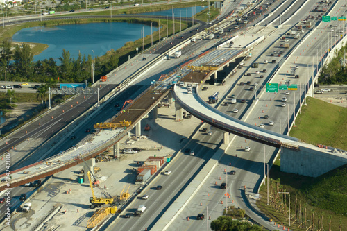 Construction roadworks on american transport infrastructure. Renovation of highway road interchange with moving traffic in Miami, Florida. Development of interstate transportation concept photo