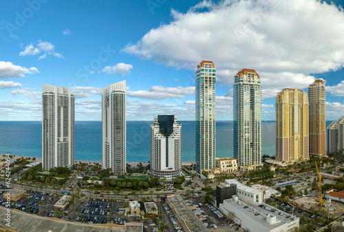 Sunny Isles Beach city with luxurious highrise hotels and condo buildings on Atlantic ocean shore. American tourism infrastructure in southern Florida