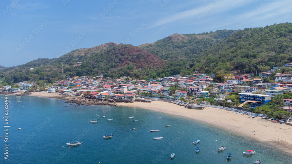 Aerial drone panorama of the village and island of Taboga, popular getaway spot close to Panama city. Visible village, houses and hills in the background.