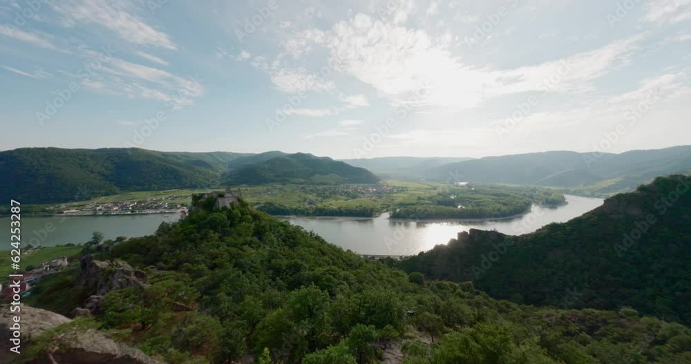 guy on top of mountain ridge, fast drone FPV, aerial shot with speed, king of the world pose, mountainclimber, person on top of hill, danube river valley landscape overview, flying around fast flying guy on top of mountain ridge, fast drone FPV, aerial shot with speed, king of the world pose, mountainclimber, person on top of hill, danube river valley landscape overview, flying around fast flying