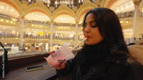 Attractive Female Tourist Inside The Elegant Shopping Center Of Galeries Lafayette Haussmann In Paris, France. Close Up photo