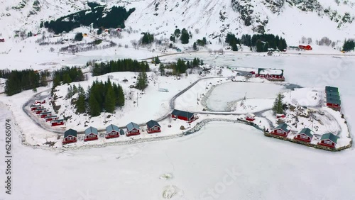 4k drone forward video (Ultra High Definition) of Kongsjordpollen fjord, Vestvagoy, Norway. Aerial winter scene of Lofoten islands. Fantastic morning seascape of frozen Norwegian sea. . photo