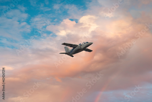 Military aircraft in flight at sunset