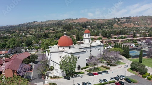 Low panning aerial shot of the Mission Basilica in San Juan Capistrano, California. 4K photo