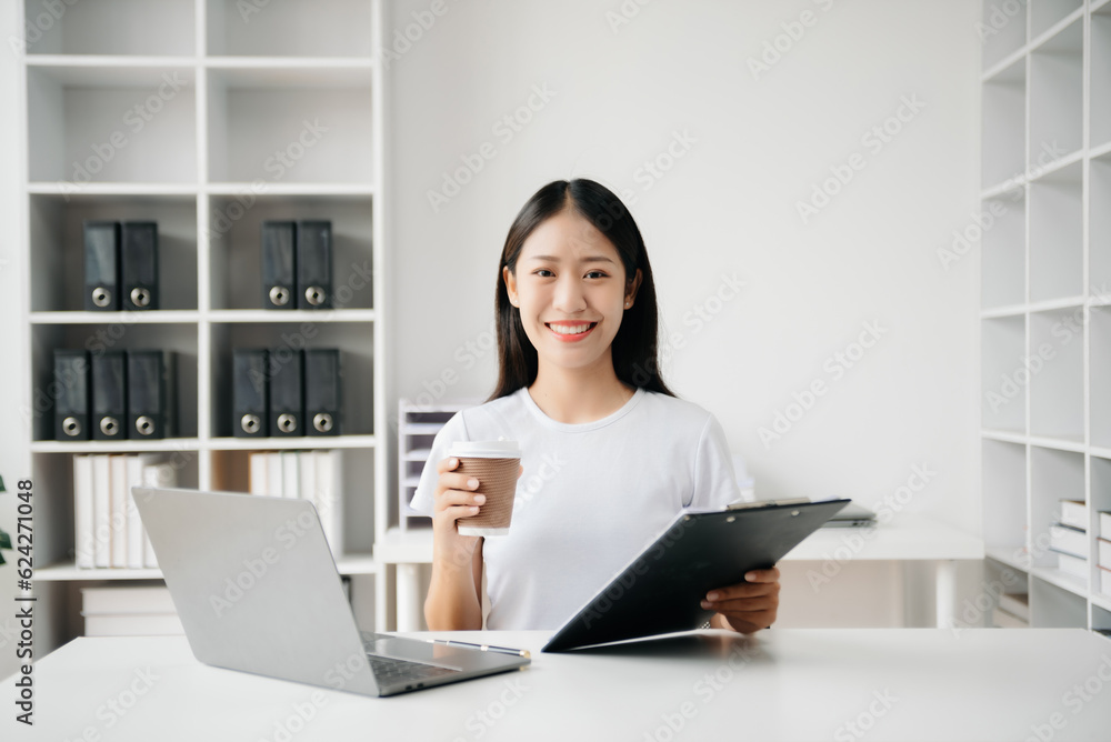 Business woman using tablet and laptop for doing math finance on an office desk, tax, report, accounting, statistics, and analytical research concept in office Business woman using tablet and laptop for doing math finance on an office desk, tax, report, accounting, statistics, and analytical research concept in office