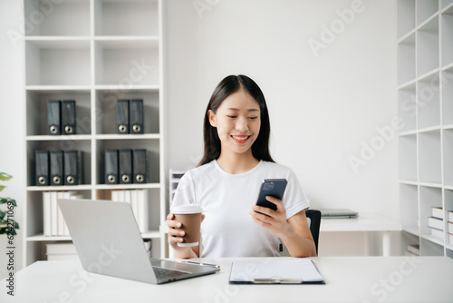 Business woman using tablet and laptop for doing math finance on an office desk, tax, report, accounting, statistics, and analytical research concept in office © laddawan