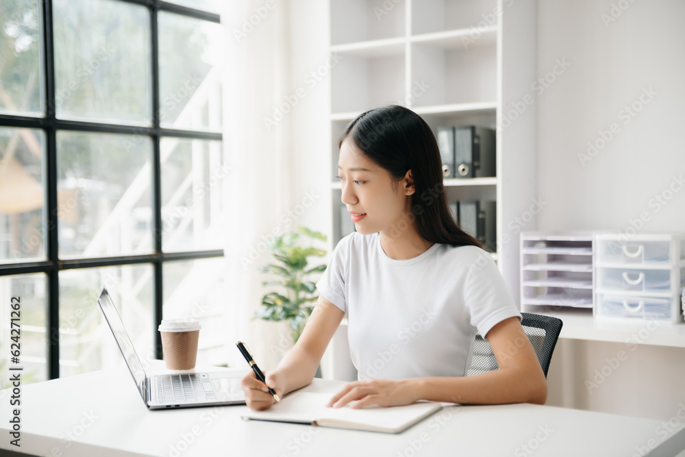 Business woman using tablet and laptop for doing math finance on an office desk, tax, report, accounting, statistics, and analytical research concept in office Business woman using tablet and laptop for doing math finance on an office desk, tax, report, accounting, statistics, and analytical research concept in office