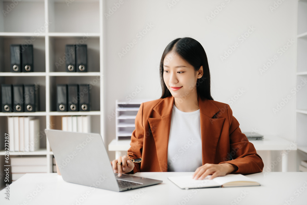 Business woman using tablet and laptop for doing math finance on an office desk, tax, report, accounting, statistics, and analytical research concept in office Business woman using tablet and laptop for doing math finance on an office desk, tax, report, accounting, statistics, and analytical research concept in office