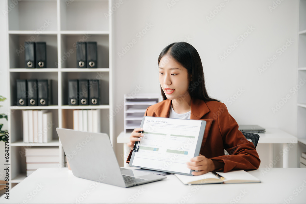 Business woman using tablet and laptop for doing math finance on an office desk, tax, report, accounting, statistics, and analytical research concept in office Business woman using tablet and laptop for doing math finance on an office desk, tax, report, accounting, statistics, and analytical research concept in office