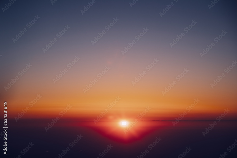Sun Shining In Sunny Clear Sky Above Dark Horizon. View From Height Flight Of Plane. Bright Yellow, Orange And Magenta Colors Of Sunny Sky. High Attitude.