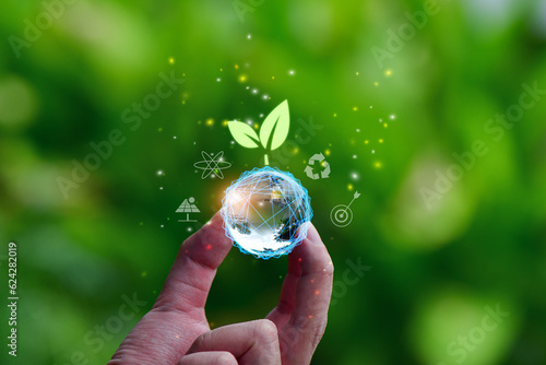 Earth  glass globe ball and tree icon in  hand saving the environment, save a clean planet, ecology concept. technology science of environment concept for the development of sustainability.