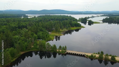 Drone shot of camps, pine trees and a dirt road in the Adirondack mountain forest preserve photo