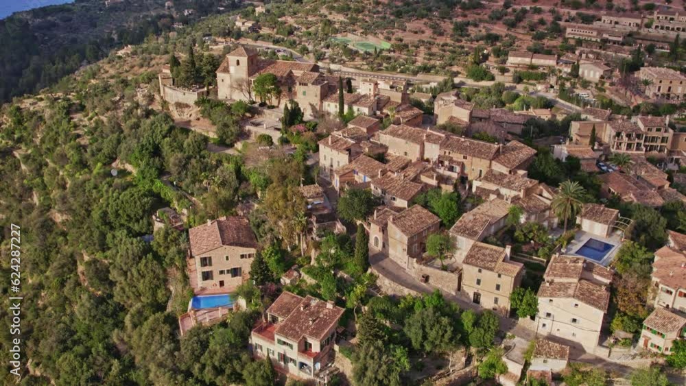 Wide shot of beautiful mountain village Deià on Mallorca during sunset, aerial Wide shot of beautiful mountain village Deià on Mallorca during sunset, aerial