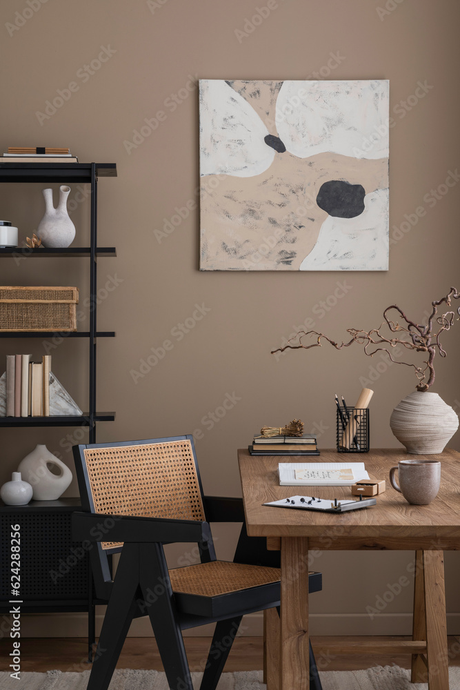 Aesthetic composition of living room interior with mock up poster frame, wooden desk, rattan chair, black rack, vase with branch, books, brown wall and office accessories. Home decor. Template. Aesthetic composition of living room interior with mock up poster frame, wooden desk, rattan chair, black rack, vase with branch, books, brown wall and office accessories. Home decor. Template.