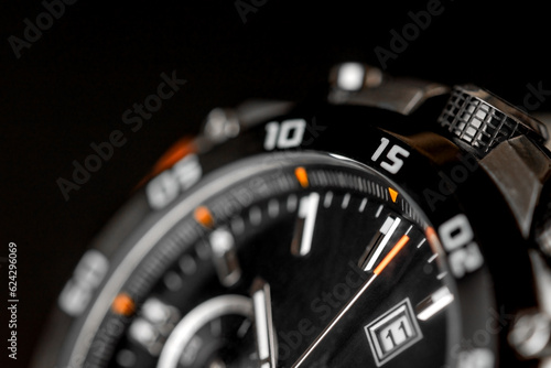 Closeup of man watch on a black background. Wrist clock. Concept image concerning time and planning activity.