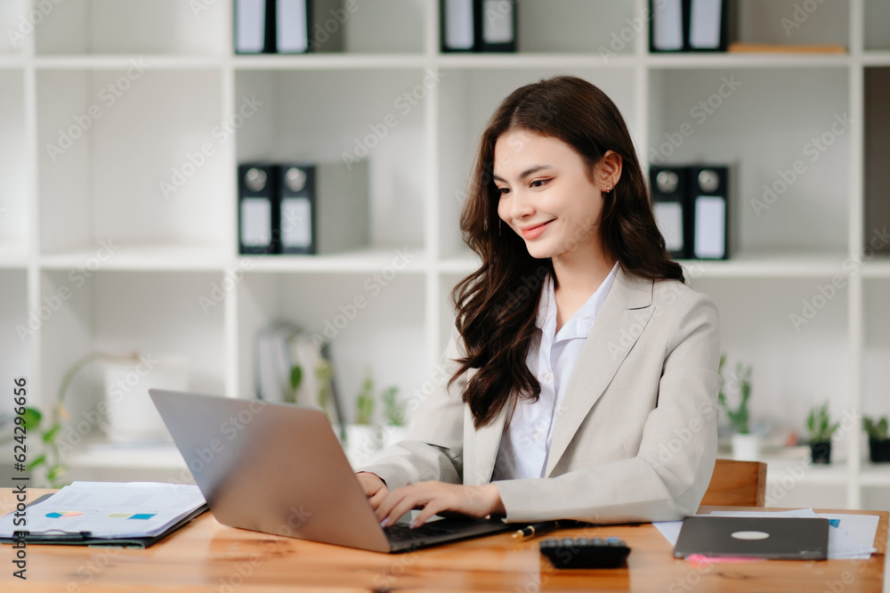 Business woman using tablet and laptop for doing math finance on an office desk, tax, report, accounting, statistics, and analytical research concept in office Business woman using tablet and laptop for doing math finance on an office desk, tax, report, accounting, statistics, and analytical research concept in office