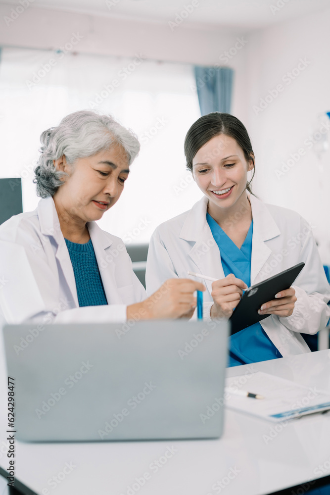 Medical Research Laboratory: Two scientists working, using digital tablets and laptop, analyzing samples, talking, developing biotechnology. Medical Research Laboratory: Two scientists working, using digital tablets and laptop, analyzing samples, talking, developing biotechnology.