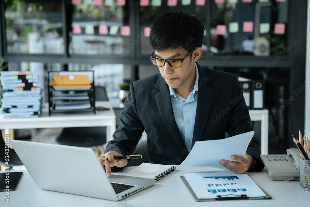 Businessman using a charts to analysis graph company financial in office. Businessman using a charts to analysis graph company financial in office.