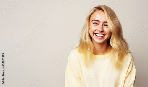  Cheerful female youngster with blonde hair, dressed casually.