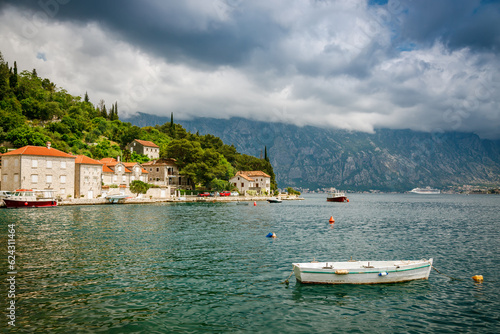 Old boat floating in the water near the Perast village in Boka Kotor bay