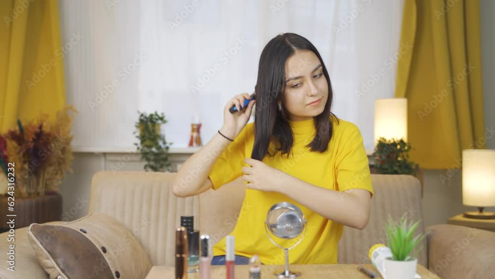 Young woman combing her hair. Hair care. Young woman combing her hair. Hair care.