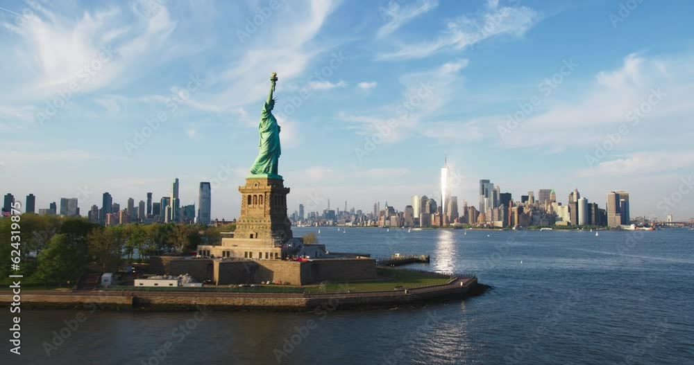 Aerial Hyperlapse Footage Passing the Statue of Liberty with Lower Manhattan Skyline Cityscape with Wall Street Office Architecture. Moving Time-Lapse of New York City Skyscrapers and Jersey City