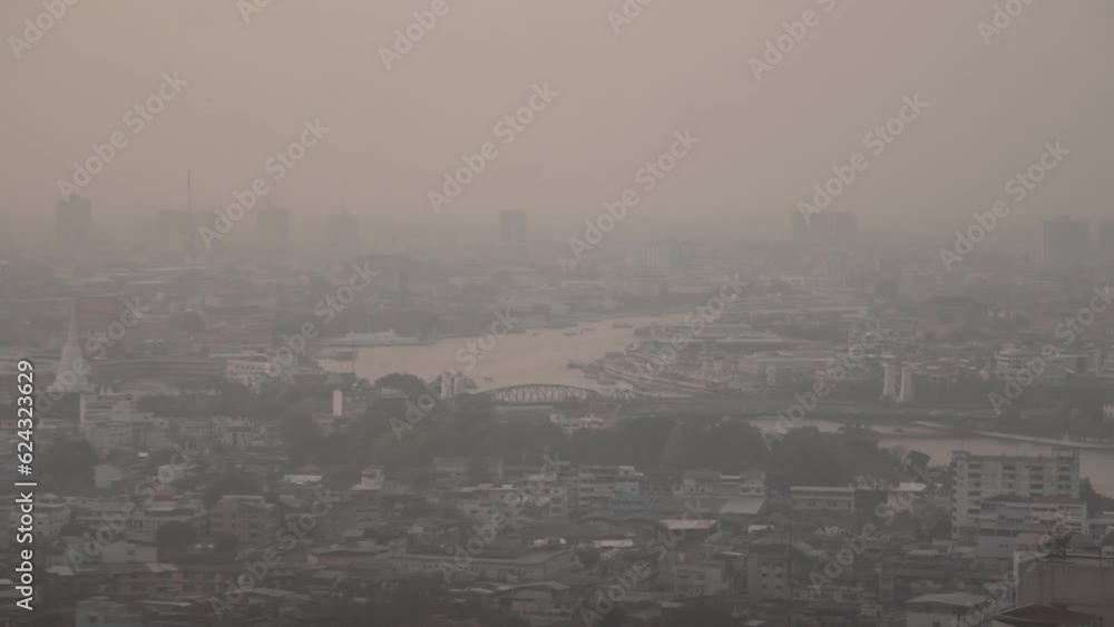 The cityscape of Bangkok is obscured by a thick blanket of dust and
